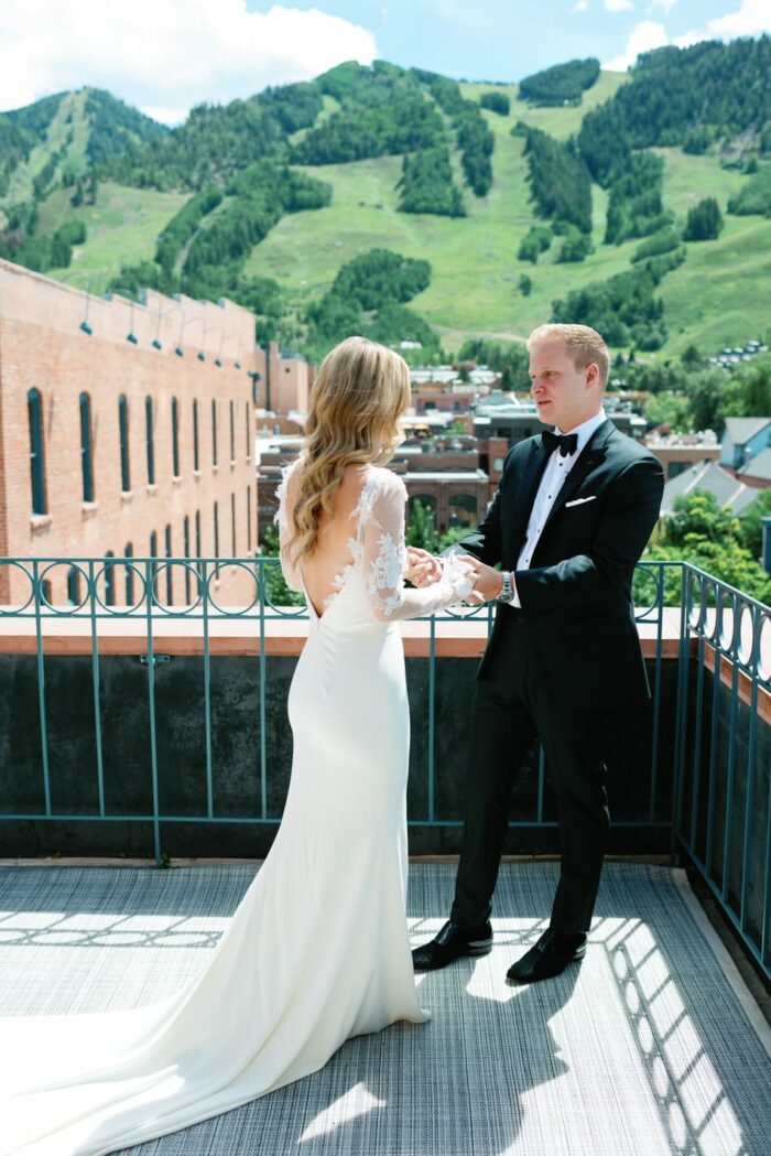 First look of bride and groom on terrace of Hotel Jerome in Aspen