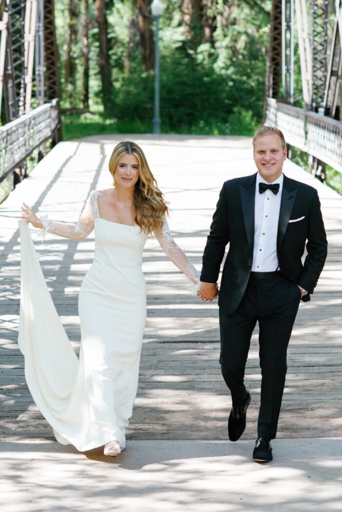 Bride and groom walking on Aspen bridge at John Denver park