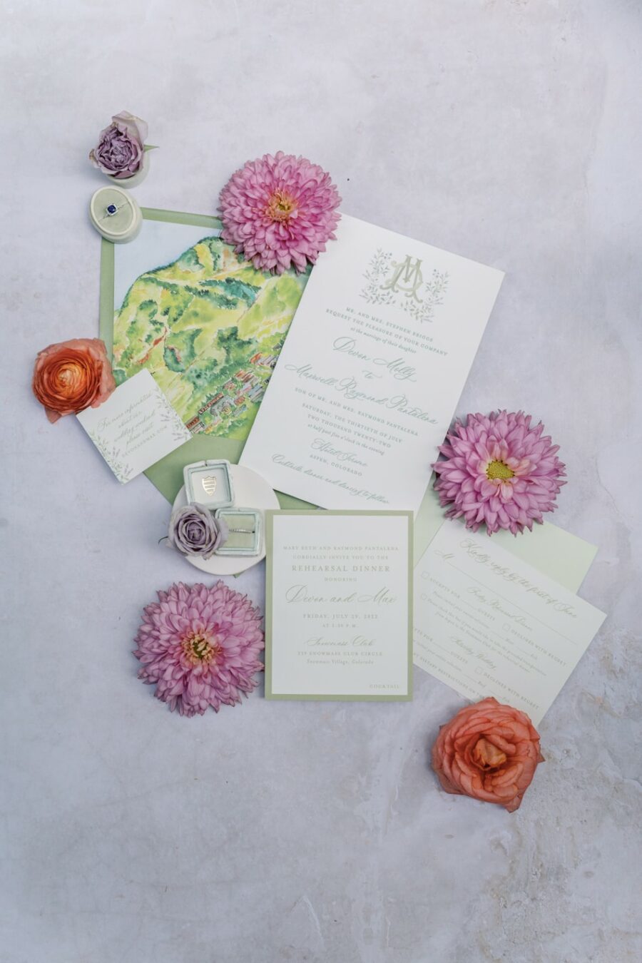 White wedding invitation suite styled on purple backdrop