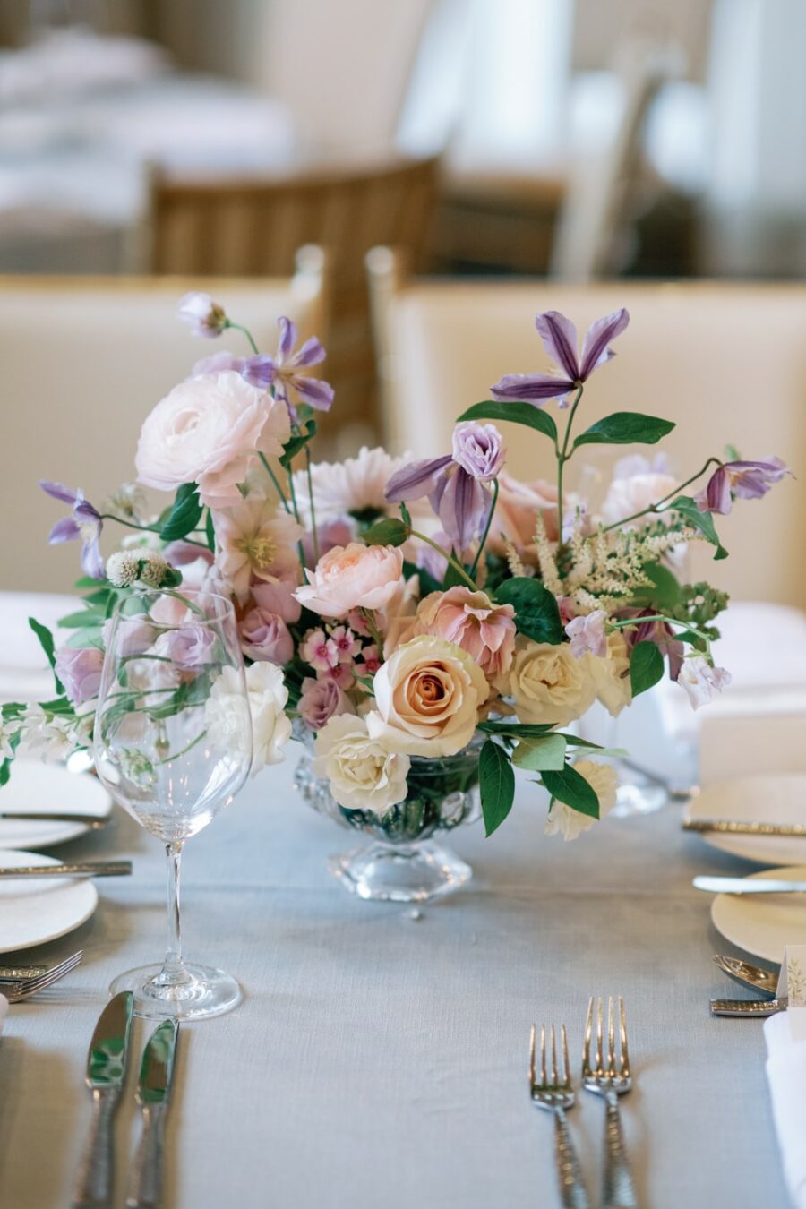 Wedding reception florals in white, blush and purple