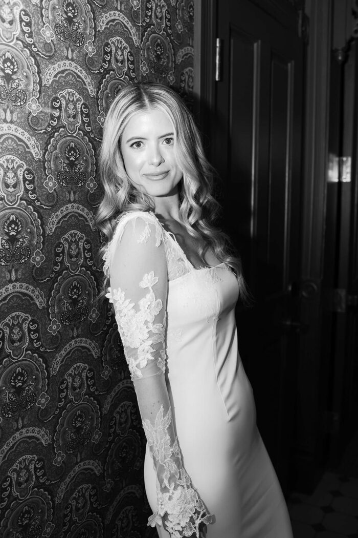 Bride leaning on wallpaper wall at Hotel Jerome in Aspen