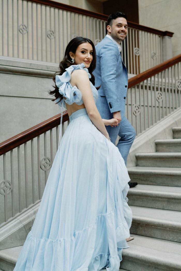 Bride and groom standing on stairs