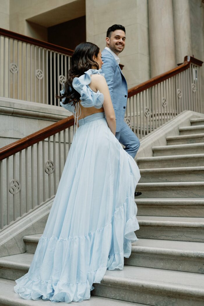 Bride and groom walking up the stairs
