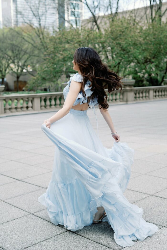 Bride walking in her blue Mac Duggal gown