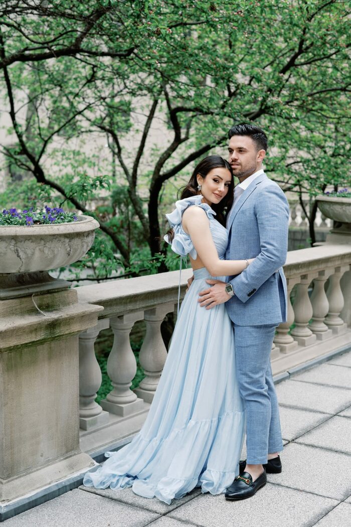 Bride and groom embracing each other outside of the Chicago Art Institute