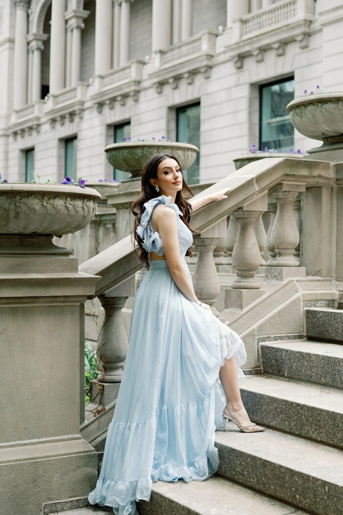 Bride wearing her blue Mac Duggal gown standing on the stairs at the Chicago Art Institute