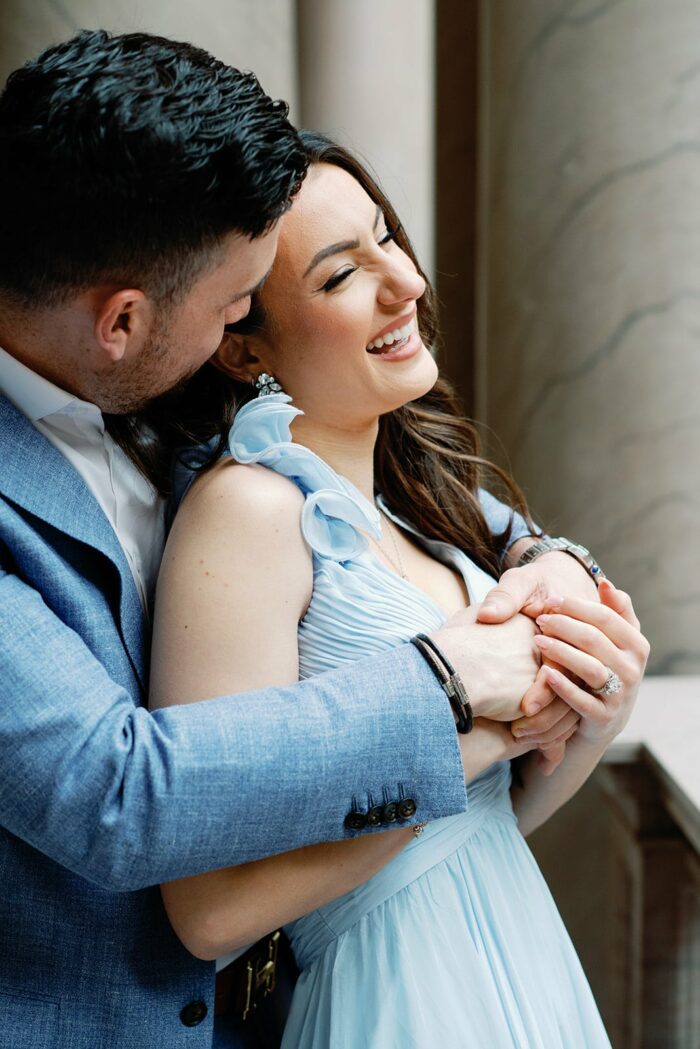 Bride and groom embracing each other smiling