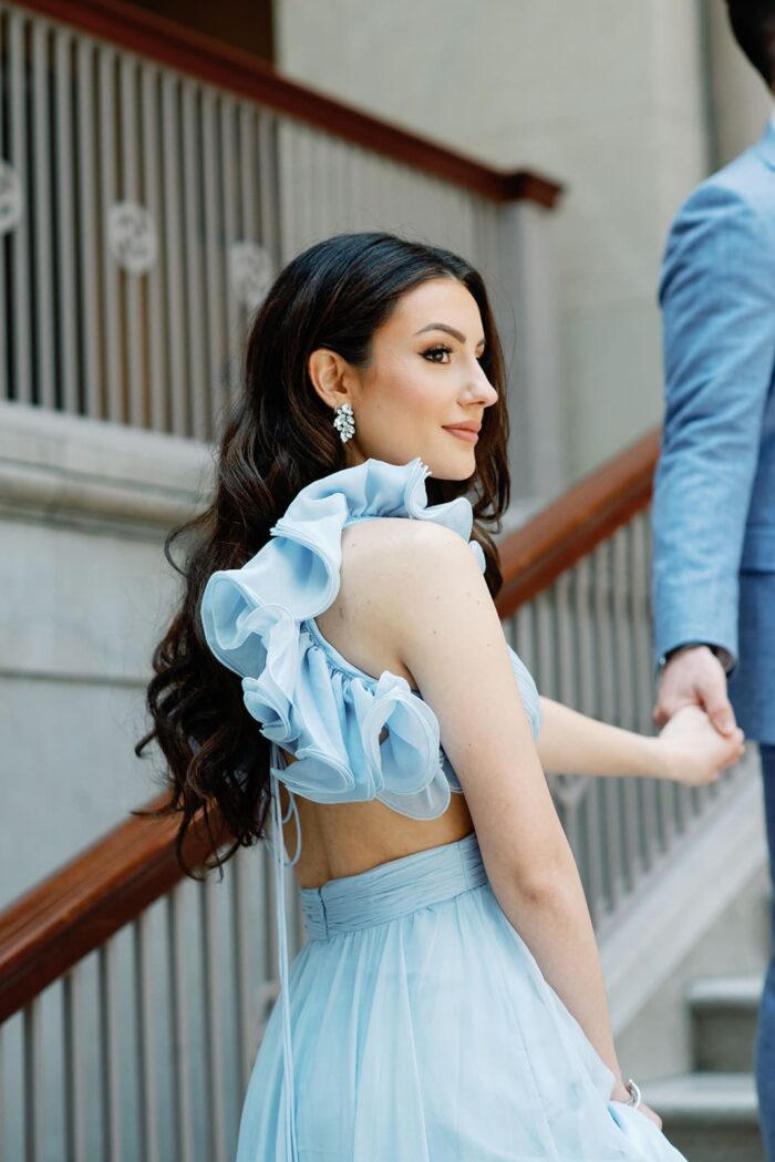 Bride in blue Mac Duggal gown with ruffle sleeves
