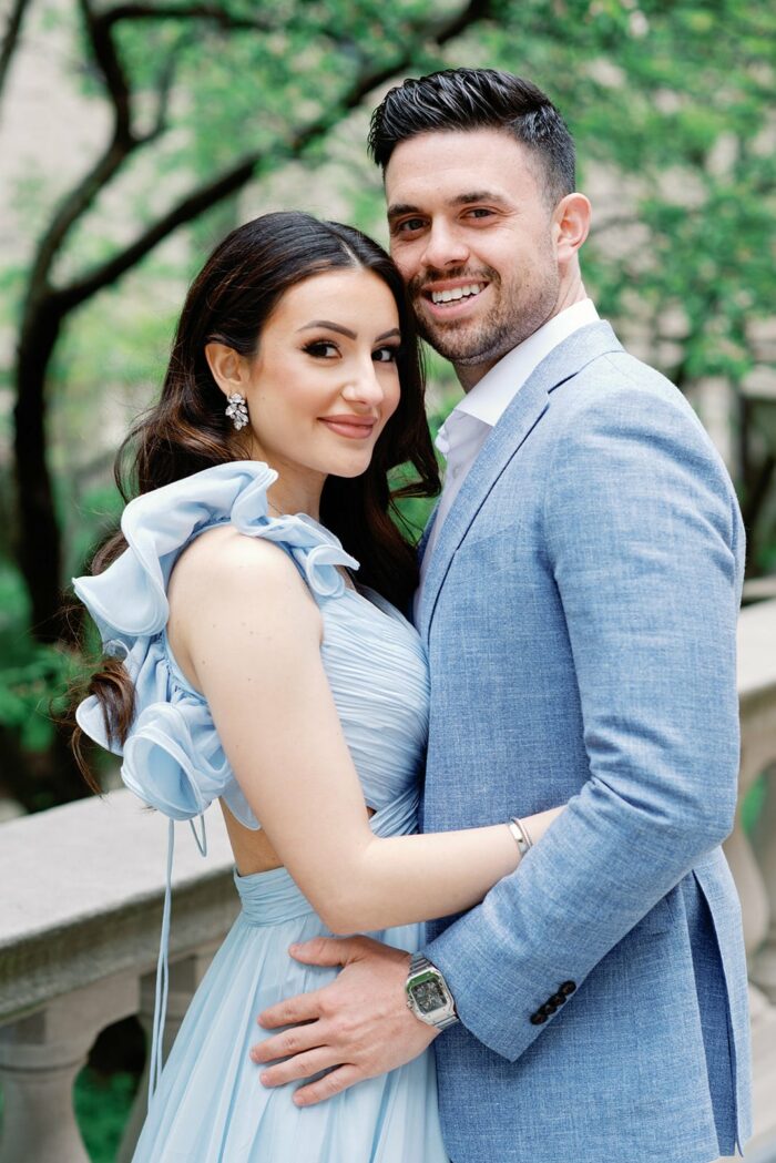 Bride and groom wearing blue and embracing each other